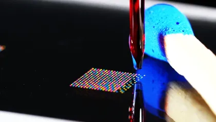 PDMD - spotting a high-density microarray of picoliter droplets using a piezo dispenser next to a match to show the miniaturisation